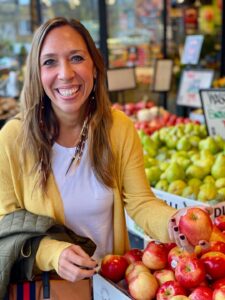smiling woman at apple stand