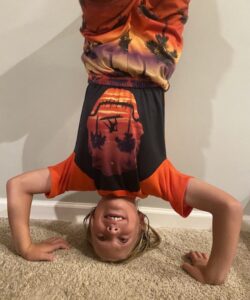 child doing headstand