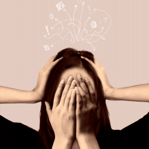Lady with hands on her head and another pair of hands in front of her face