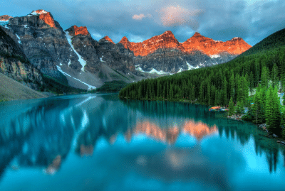 Image of a lake and forest with mountains in the background